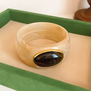 Retro acrylic wide bangle bracelet with marbled texture and decorative oval resin inlay stone
