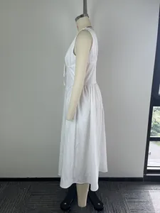 Side view of elegant white sleeveless midi dress with cinched waist on mannequin