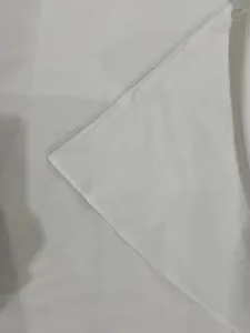 Close-up of high-quality white fabric and hem stitching for elegant backless long dress