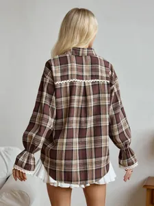 Back view of retro brown plaid shirt with delicate white lace trim and puffed sleeves.
