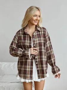 Detailed view of women's vintage loose plaid shirt with lace-trimmed bell sleeves