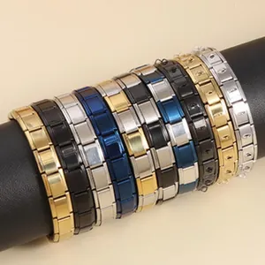 Close-up of modular titanium steel link bracelets in multiple colors on a display stand