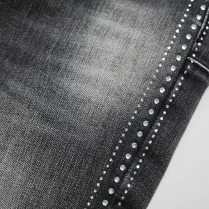 Macro view showing the sparkling rhinestone detailing on black denim high street flare jeans
