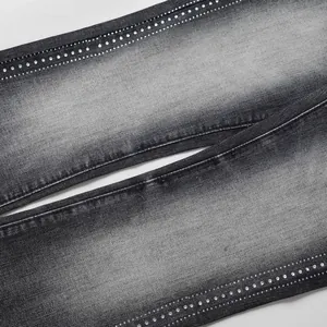 Close-up of rhinestone detailing on washed grey high street flared jeans for men