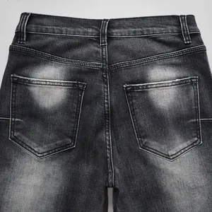 Close-up detail of back pockets and washed texture on men's black high street flared jeans
