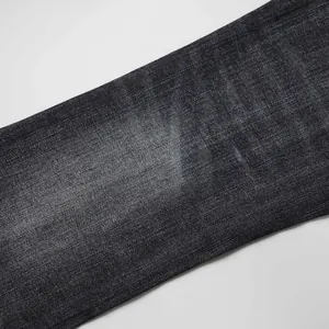 High-quality macro view of black washed denim fabric showing texture and subtle fade