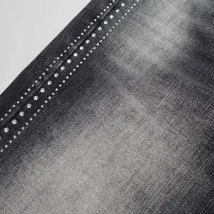 Close-up of exquisite rhinestone detailing on high street black flare denim pants