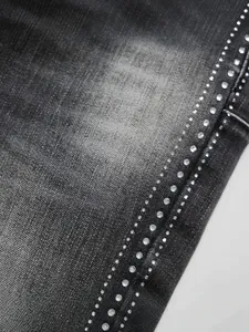High street men's black flare jeans detail with triple-row rhinestone trim on denim fabric