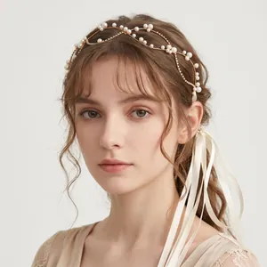 Detailed view of an elegant bridal pearl headband accessory with long white silk ribbons