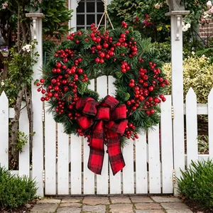 Christmas wreath with red black plaid bow and berries for outdoor door decoration
