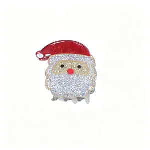 Macro view of a cute glittery Santa Claus hair claw clip accessory for Christmas.