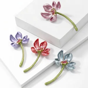 Detailed view of alloy enamel lotus brooches in four elegant colors with pearl accents