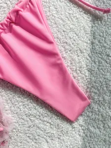Detailed macro view of the smooth pink fabric texture on a fashionable bikini swimsuit