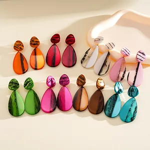 Detail view of multi-colored marbled resin drop earrings in vibrant hues