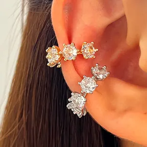 Macro view of sparkling round zirconia ear cuffs in both gold and silver finishes