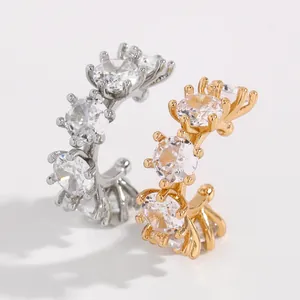 Detail of elegant silver and gold ear cuffs set with sparkling round cubic zirconia.