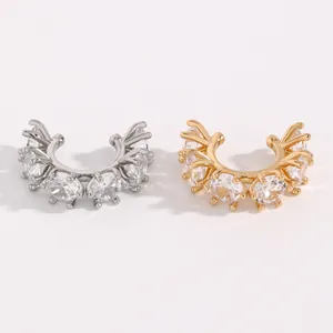 Detailed view of silver and gold zirconia ear cuffs with sparkling clear stones