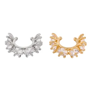 Detailed macro shot of silver and gold geometric ear cuffs with clear cubic zirconia
