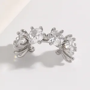 Macro view of silver-toned ear cuff featuring four brilliant round zircon stones