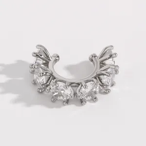 Macro detail of a silver-toned ear cuff set with brilliant round cubic zirconia stones.