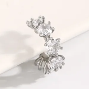 Close-up detail of a silver-tone ear cuff set with multiple round clear cubic zirconia stones