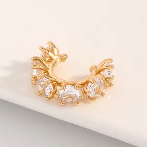 Macro view of gold-plated geometric ear cuff with sparkling round brilliant-cut zircons