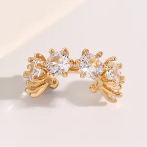 Close-up of elegant gold-plated ear cuff with four sparkling round cubic zirconia stones.