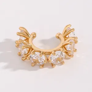 Close-up of elegant gold-plated ear cuff featuring multiple sparkling round zircons