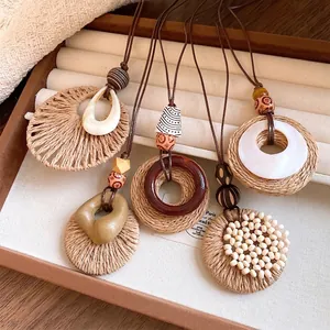 Bohemian style necklaces featuring raffia circles, wooden beads and long leather cords