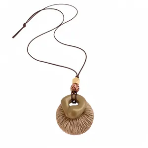 Bohemian round raffia necklace with wood beads and resin pendant on leather cord