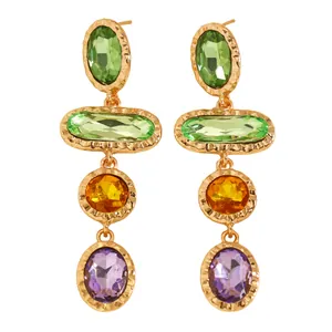 Close-up of elegant gold-plated drop earrings with colorful geometric rhinestones.