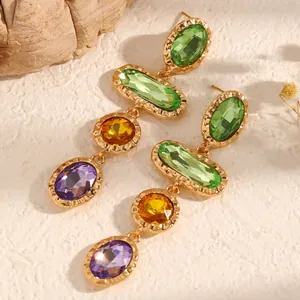 Detailed view of colorful geometric crystal drop earrings with gold-tone settings.