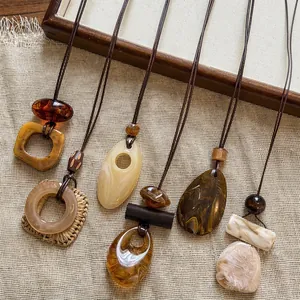 Detailed view of retro marbling resin pendant necklaces displayed on burlap fabric