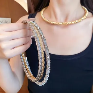 Elegant minimalist gold and silver twisted metal neck ring with vintage braided texture