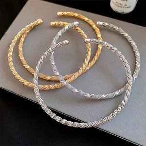 Detailed view of twisted metal collar necklaces in gold and silver retro vintage style