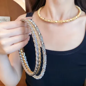 Detailed view of vintage twisted metal choker necklace in gold and silver finishes