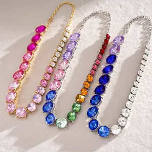 Macro detail view of colorful gradient round crystal necklaces in gold and silver settings.