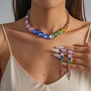 Close-up of rainbow gradient rhinestone necklace and dangling earrings set on model