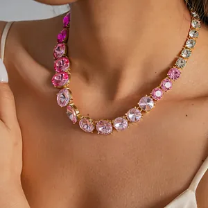 Close-up of a gradient pink rhinestone round necklace on a model's neck