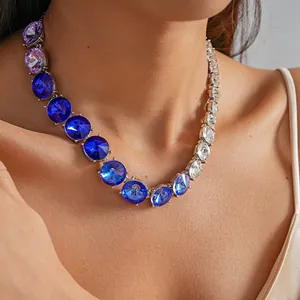 Detailed close-up showing a gradient round crystal statement necklace on a model
