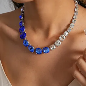 Close-up of a luxury blue and white rhinestone gradient round necklace on a model
