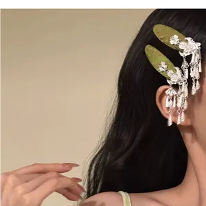 Close-up of elegant Chinese style silver bell tassel hair clips on black hair