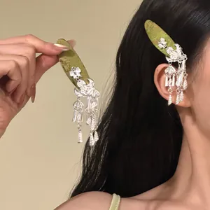Elegant silver hair clip featuring traditional bell tassels and intricate moon design