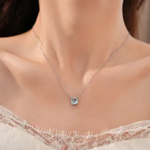 Elegant silver clavicle necklace with a square light blue zircon pendant on an Asian model