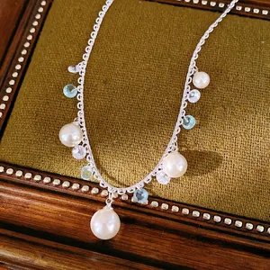 Elegant silver zircon tassel and pearl necklace with light blue stones on velvet box