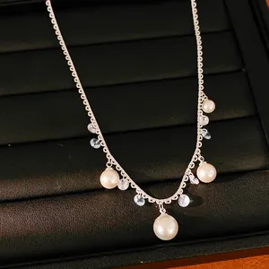 Macro view of silver lace chain necklace featuring elegant pearls and zircon tassels