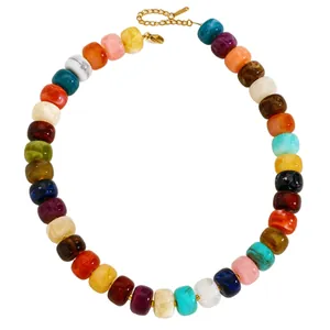 Close-up of colorful chunky resin beads necklace with gold-plated clasp and extender chain.