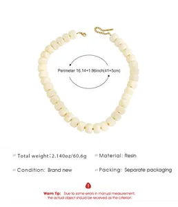 Size detail of cream resin beaded choker necklace with gold-plated chain and clasp