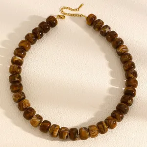 Macro detail of chunky brown marble pattern beads on a vintage style necklace