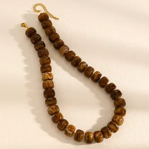 Detailed close-up of brown marble textured resin beaded necklace with elegant gold clasp